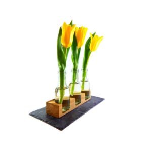 Blumenvase mit Glasfläschchen und Schieferplatte